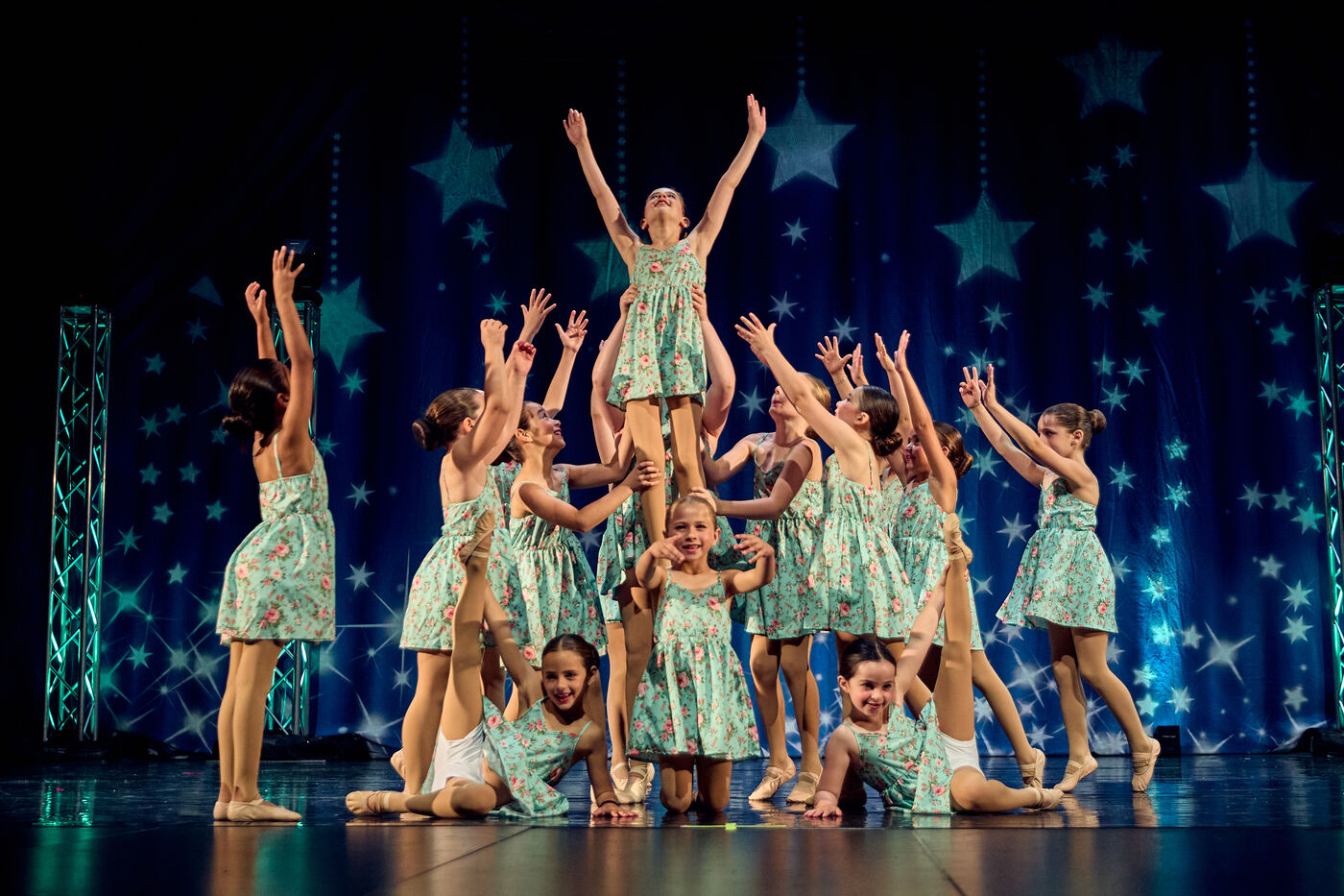 AFDS dancers in green costumes in a group formation