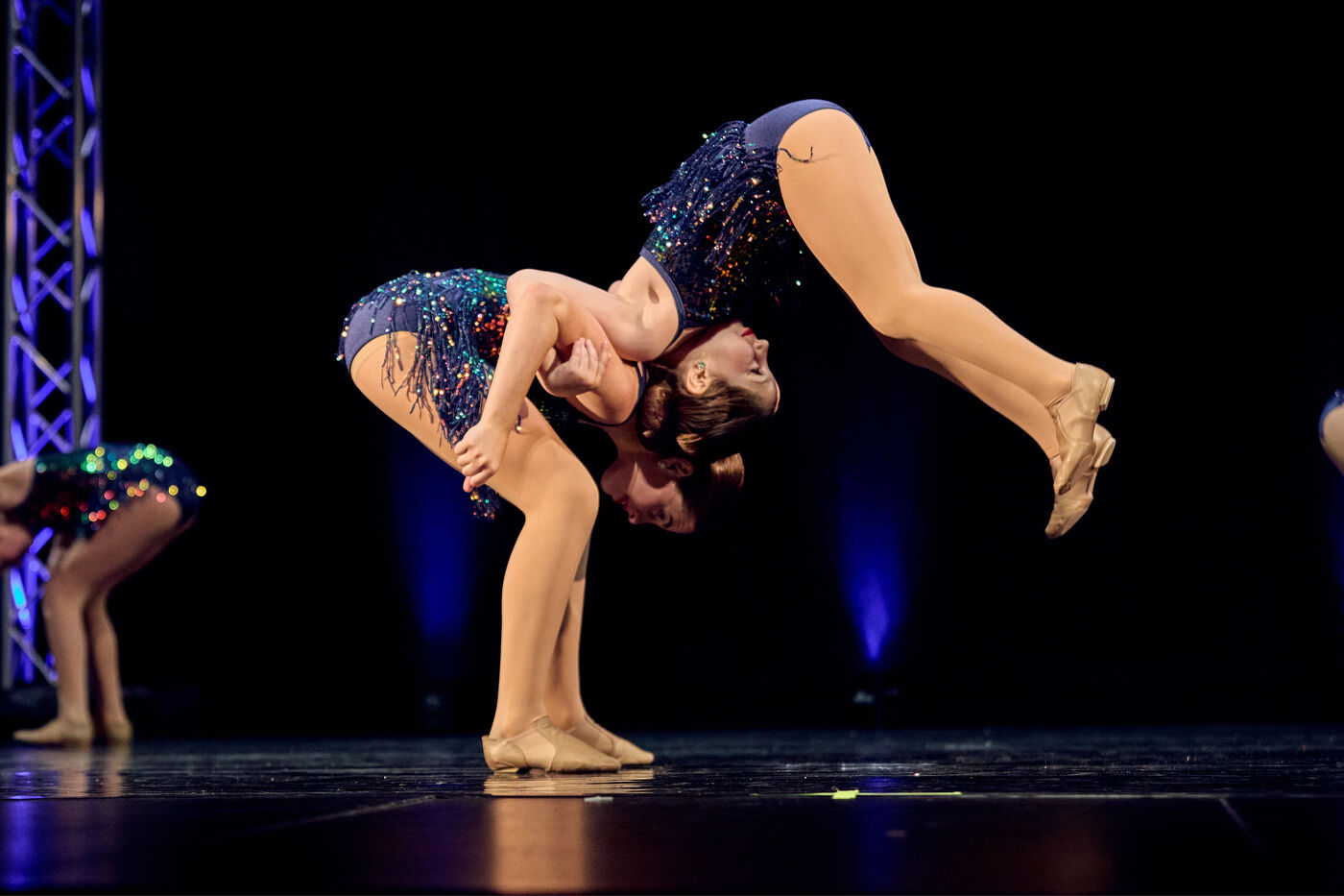 Two Synergy dancers performing a partnered lift