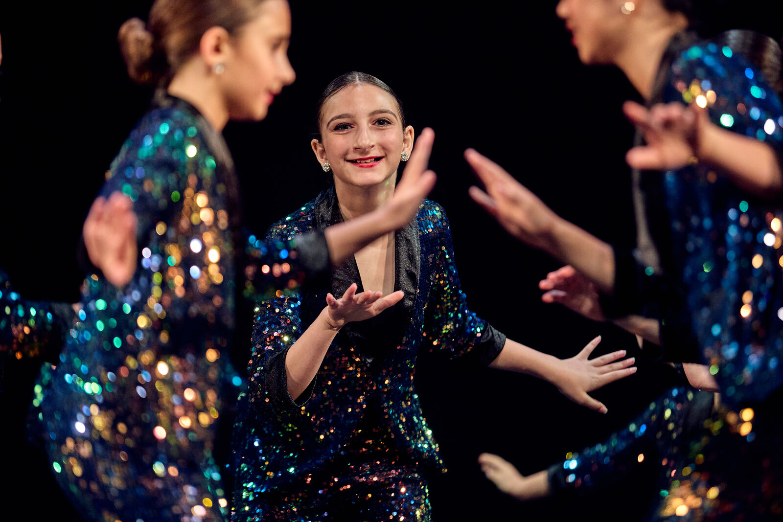 AFDS dancers in sequined jackets performing together